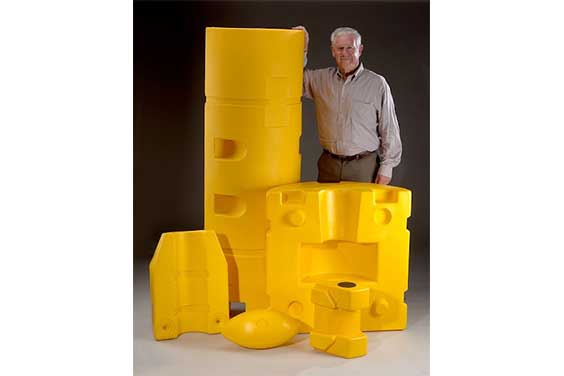 A man holding rotational molded products