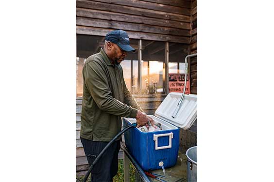 Man cleaning the inside of a cooler