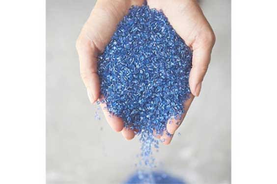 Person holding plastic pellets for injection molding